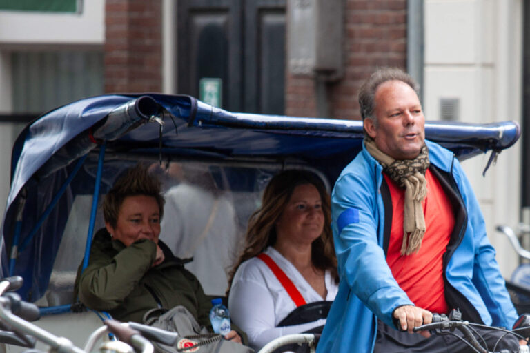 dutch pedicab driver with customers